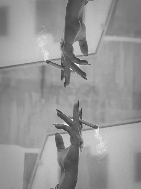 Black and white reflection of hands on glass