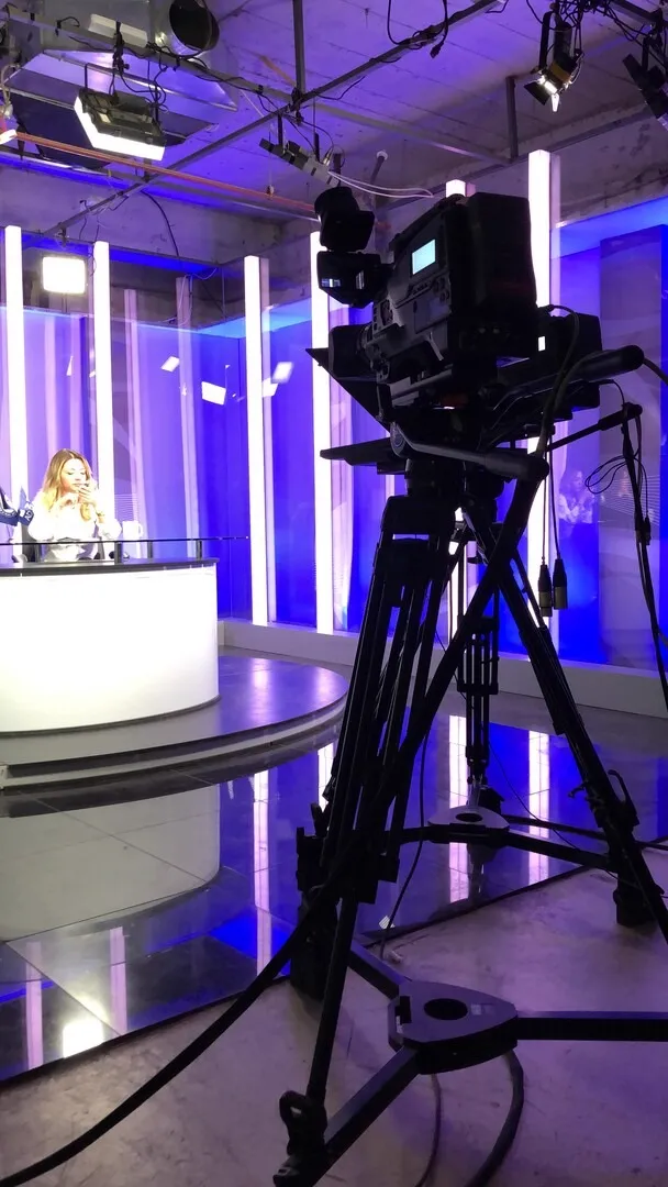 Studio camera facing a news desk